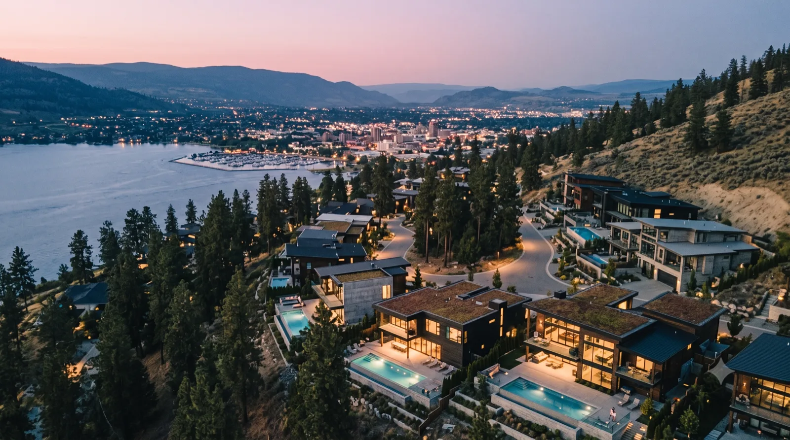 Wilden at Dusk — forest-modern homes tucked into the ponderosa pines, warm windows glowing on as the valley lights come up at blue hour