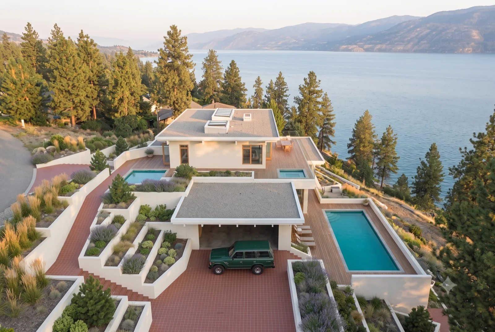 Terraced to the lake, Raised planters and a lap pool stepping down the slope, the rig in the port, the lake filling the far edge.