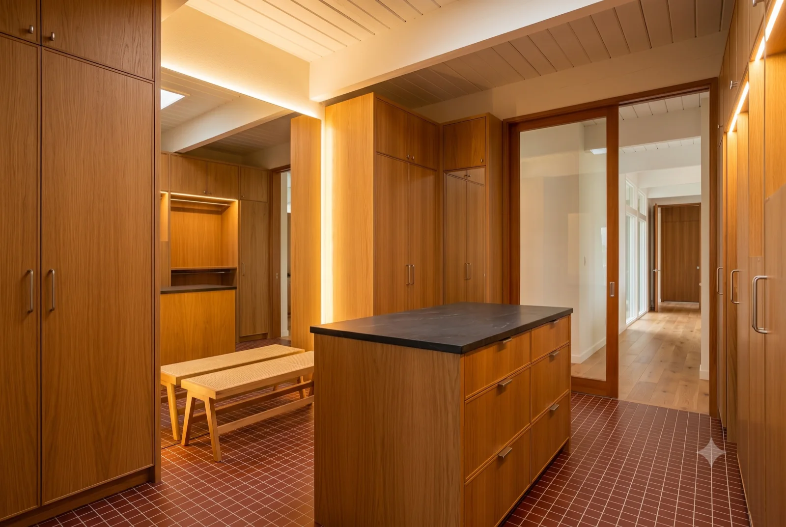 The working kitchen, A butcher-block island and full-height pantry, terracotta floor, everything within a step.