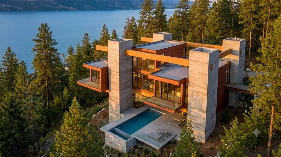 The Kelowna Kappe — redwood and glass floating on concrete towers, stepping down the forested slope